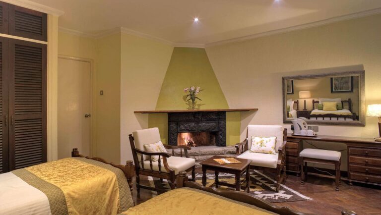 Helles Zimmer mit Kamin, afrikanische Inneneinrichtung, Safari Urlaub, Afrika Reisen.