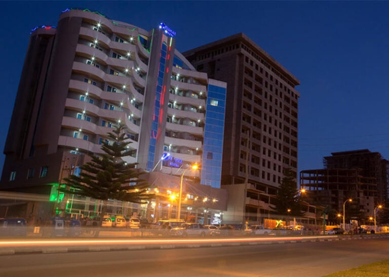 Modernes Hotel in Afrika bei Nacht, Stadtansicht mit Lichtern, Urlaub und Reise in Afrika.
