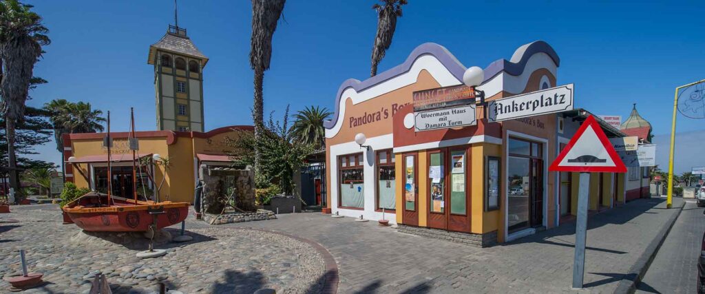 Hübscher afrikanischer Stadtplatz mit bunten Gebäuden und Wasserfontäne.