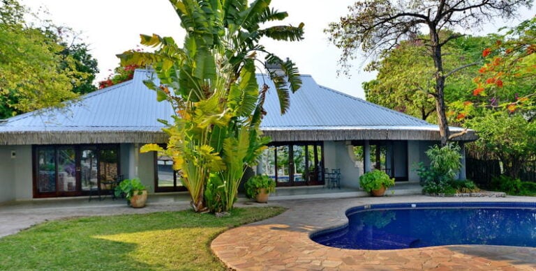 Alt: Traumhafte afrikanische Lodge mit Pool und Pool im Garten, perfekte Safari-Unterkunft.