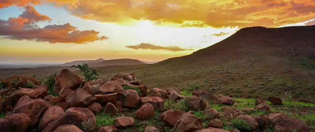 Atemberaubende afrikanische Wüstenlandschaft mit rotem Sand und Bergen.