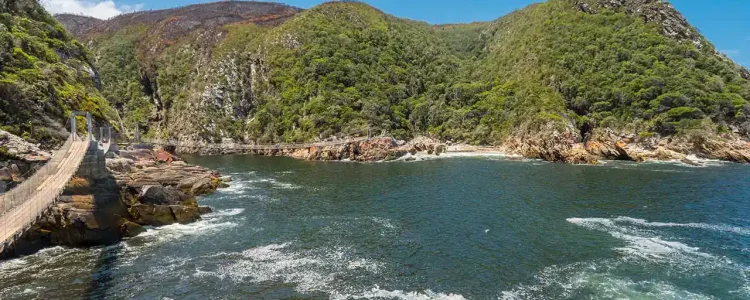 Hochauflösender Blick auf den Bloukrans-Fluss und grüne Hügel entlang der Küste.